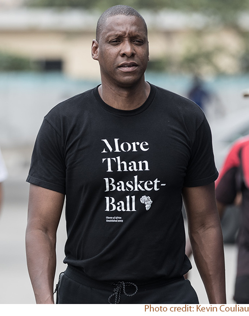 Masai Ujiri, founder of Giants of Africa wearing a black custom t-shirt with their custom design.